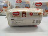 three packages of baby diapers sitting on top of a table