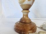 a vase that is sitting on a table next to a tea cup