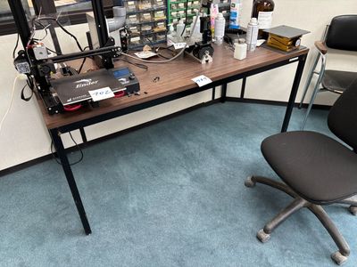a desk with a chair and a computer on it