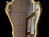 a mirror that is sitting on the wall in front of a window