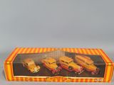 an orange and yellow box with three toy trucks in it