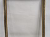 a gold frame with a white background and a white wall