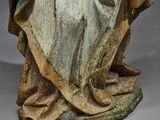 an old statue of a woman holding a baby in her arms