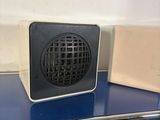 a blue counter top with a black and white speaker on top of it