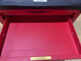 the red tool box is open to show the contents of the tool