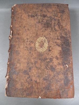 an old book sitting on top of a table covered in dirt