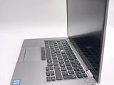 a silver laptop computer sitting on top of a white table