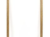 a gold picture frame on a white wall with a white background