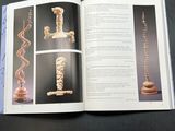an open book with a picture of a sculpture on it