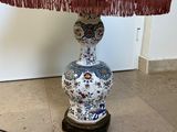 a lamp that is sitting on a table with a lamp shade on it