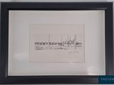 framed drawing of a line of boats on the water in a black frame