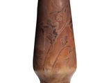 a brown vase that is sitting on a white surface