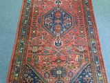 a red and blue rug on a blue floor