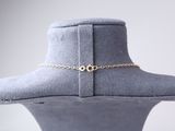 a close up of a mannequin wearing a hat with a chain around it