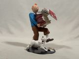 a figurine of a man with an accordion and a dog