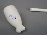 a figurine of a fish and a pen on a table