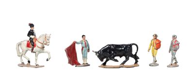 five figurines of people riding horses and a bull