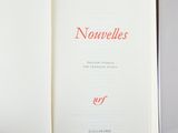 an open book with red writing on it sitting on a table