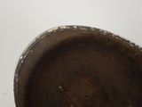 a close up view of a dirty pot on a table