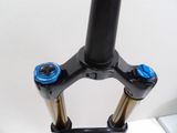 a close up of a bike ' s front end with two blue knobs on it