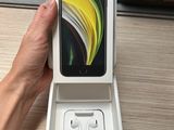 someone is holding a box with a phone in it on a table
