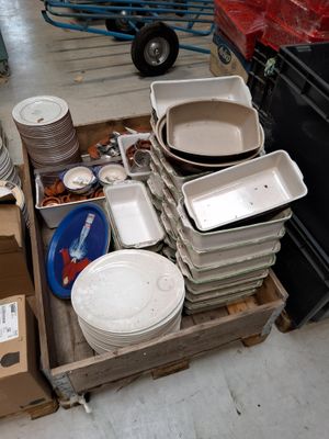 a lot of plates and pans sitting in a box