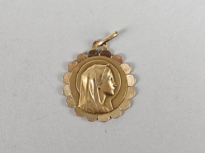 an image of a gold medal with a woman ' s face on it
