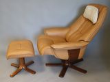 leather reclining chair with footstop and ottoman in front of a gray wall
