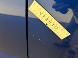a yellow sticker on the side of a blue car