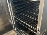 a large oven that has many racks of food inside of it