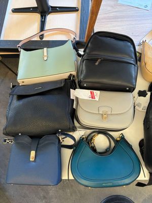 a lot of purses that are sitting on a table