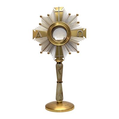 une image représentant une croix dorée sur laquelle est posé un miroir