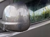 reflection of a car ' s side mirror on a car ' s side mirror