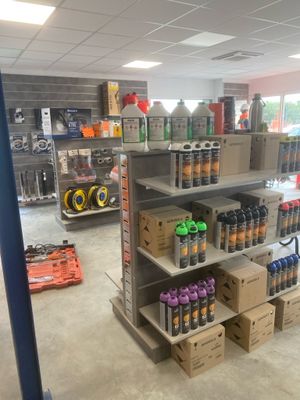 many cans and cans of soda on the shelves in the store