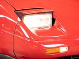 a close up of a red car with a light on