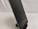 a tablet that is sitting on a stand on a table