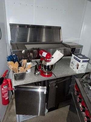 a kitchen with a stove, oven, sink, and other appliances