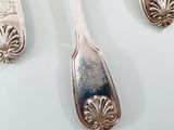 three spoons and two spoons on a table