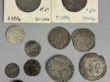 some coins are sitting on top of a table next to a piece of paper