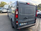 a grey van parked in a parking lot with other cars