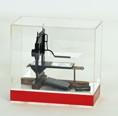 a small model of a gun in a display case