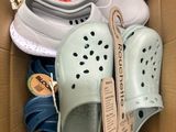 several pairs of shoes in a box on the floor