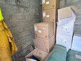 a pile of boxes in a storage room next to a wall