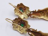 two pairs of gold earrings with green and red stones on them