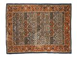 an antique persian rug with a floral design on a blue ground