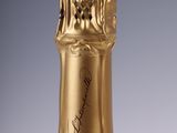 bottle of champagne with a gold cap on a white background