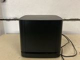 a small black box sitting on top of a table next to a wall
