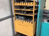 an image of a rack of tools in a garage with a door open