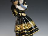 an image of a figurine of a woman in a dress and hat