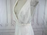 a picture of a white wedding dress on a mannequin
